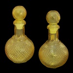 Par de garrafas decorativas de vidro amarelo com padrão em relevo bico de jaca. Corpo bojudo e redondo com relevo geométrico.  20 x 11 cm.