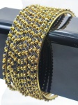 BIJUTERIAS, dez (10) braceletes, confeccionados em metal dourado com decoração perolada, incrustação de granulados pretos (imitando pedra), 1 deles necessita solda, medindo 7cm de diâmetro.