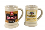 CERÂMICAS, duas (2) canecas confeccionada em cerâmica vitrificada na tonalidade creme, com alças laterais vazadas e decoração publicitária de cervejarias, sendo uma com rótulo Bock Polar e uma com rótulo Bohemia Cerveja Pilsen, medindo 14x13x9cm, Bohemia possui fio de cabelo. e Bock com alça com fio de cabelo.