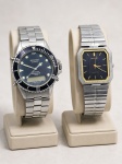 RELÓGIOS, dois (2) relógios de pulso, sendo: A) 1 da marca Technos, modelo Skydiver Professional 150m, referência 7206/01, em versão Quartz / Chronoalarm, com caixa e pulseira metálicas, aro giratório e mostrador analógico com visor digital, medindo 4cm e B) 1 da marca Orient, modelo/referência 7430-5050, com caixa retangular, mostrador escuro com detalhes dourados, movimento Quartz, caixa e pulseira metálicas com sinais de oxidação, medindo 2,7x2,7cm. Peças usadas, não testadas e sem garantia de funcionamento.