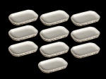 <b>NORITAKE & VARIG</b>, dez (10) petisqueiras confeccionados em porcelana esmaltada na tonalidade branca, formato oitavado, bordas decoradas por guirlanda de folhagens e filetes em prata, alguns apresentando pequenas falhas na prateação, medindo 17x10cm.