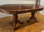 MAGNÍFICA MESA DE JANTAR OVAL EM MADEIRA NOBRE, ESTILO NEOCLÁSSICO / IMPERIAL.  TAMPO OVAL COM SISTEMA DE EXTENSÍVEL. (ACOMPANHA TÁBUA), SAIA RICAMENTE TRABALHADA COM ENTALHES EM RELEVO DECORADA COM MOTIVOS FLORAIS (ROSETAS) E FRISOS VERTICAIS RITMADOS, BASE SUSTENTADA POR  DOIS ROBUSTOS PEDESTAIS TIPO BALAÚSTRE CUIDADOSAMNETE ENTALHADOS COM FOLHAS DE ACANTO EM RELEVO .TAMPO COM MARCAS DE USO. MEDIDAS:  240 CM ABERTA / 190 CM FECHADA X 100 CM DE LARGURA E 80 COMP. APRESENTA VETÍGIOS DE CUPIM