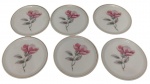 Schmidt. Conjunto com 6 porta-copos em porcelana esmaltada, decorados com motivo floral policromado ao centro e bordas filetadas em ouro. Manufatura marcada no verso. Medidas: 9 cm de diâmetro.
