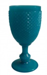 Antiga taça em opalina azul, com bojo ornamentado em relevo geométrico em padrão diamantado, haste torneada e base circular. Medidas: 15 x 7,5 cm.