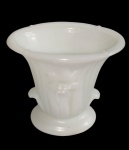 Antigo vaso em opalina branca, com corpo em relevo moldado por caneluras verticais e motivos florais, borda expandida e base circular. Medidas: 11 x 8 x 12 cm.