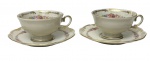 KPM, Poland. Par de xícaras de coleção para café em porcelana esmaltada e vitrificada, acompanhadas de seus respectivos pires. Decoração floral policroma com guirlandas, bordas em relevo e acabamento com frisos dourados. Manufatura na base.