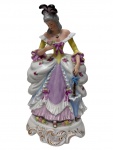 Escultura em porcelana policromada representando Dama da Corte, ricamente modelada, trajando vestes de inspiração Rococó, com delicada decoração floral em relevo, sombrinha junto à base e detalhes realçados em douração.Medidas: 31 x 17 x 16 cm.