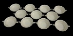 Théodore Haviland, France. Onze (11) xícaras para consommés em porcelana francesa, na cor branca com filetes em prata. Um consommé apresenta pequeno bicado. Medidas: 4 x 16,5 x 12,5 cm. Faltam pires.;