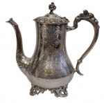Grande e imponente bule em metal espessurado a prata, marcado na base EPNS, com corpo bojudo ricamente cinzelado em decoração de folhagens, volutas e concheados. Tampa articulada com borda ornamentada e pega em forma de flor, bico vertedor alongado e alça vazada de inspiração Rococó. Apoiado sobre pés recortados. Medidas: 23 x 23,5 x 13 cm.