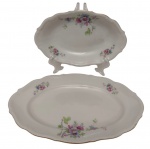 C.T. Poland - Duas tarvessas  em porcelana polonesa esmaltada, com decoração floral policromada, bordas recortadas e filetadas a ouro. Marcadas na base. Medidas: 3,5 x 29 x 19,7 cm e 3 x 23 x 15 cm