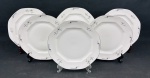 Czechoslovakia. Seis pratos rasos em porcelana esmaltada, de formato oitavado, decorados com delicados ramos florais em grisaille e filetes em prata. Manufatura no verso. Medidas: 24 cm.