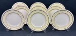 Johnson Bros.,England. Nove pratos rasos em faiança inglesa, padrão Old English, com borda serrilhada, ornamentada em relevo, aba em tom creme sobre fundo marfim e detalhes e filetes em ouro de motivos florais. Manufatura no verso. Medidas: 25 cm de diâmetro. Craquelê, 2 com manchas e um com bicado.