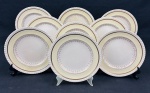 Johnson Bros.,England. Nove pratos sobremesa em faiança inglesa, padrão Old English, com borda serrilhada, ornamentada em relevo, aba em tom creme sobre fundo marfim e detalhes e filetes em ouro de motivos florais. Manufatura no verso. Medidas: 20 cm de diâmetro. Craquelê. 3 com manchas