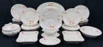 Tielsch & Co. à Altwasser, Germany - Serviço para jantar parcial em porcelana alemã decorado com flores e folhagens policromadas sobre fundo branco, bordas com frisos a folha de ouro. Composto de 8 pratos rasos, 12 pratos fundos, 1 terrina, 3 saladeiras, 1 molheira, 1 espinheira  e 4 travessas. Manufatura na base. Medindo respectivamante: 24 cm, 4 x 25 cm, 15 x 27 cm, 6 x 25 cm, 6 x 21 x 21 cm, 9 x 15 x 21 cm, 14 x 22 cm, 20 x 29 cm, 22 x 31 cm, 25 x 35 cm e 30 x 43 cm. Uma saladeira com fio de cabelo.
