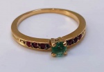 Meia aliança modelo HSTERN em OURO 18 K com esmeralda central e 6 pedras de rubi cravejadas . Aro: 12 - pesa: 2,12 g .
