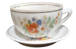 POZZANI - ANTIGA XÍCARA DE CHÁ COM PIRES M PORCELANA CANELADA COM DECORAÇÃO FLORAL. COM BICADO NA BORDA DA XÍCARA. MEDINDO A XÍCARA 5 X 8 X 10 CM E O PIRES 10 CM
