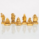 Conjunto de sete(07) figuras representando os Shichifukujin - Sete Deuses da Fortuna da tradição japonesa. Esculturas moldadas em material sintético de tonalidade marfim, cada qual sobre base individual, representando Ebisu, Daikokuten, Bishamonten, Benzaiten, Hotei, Fukurokuju e Jurojin, divindades associadas, na cultura japonesa, à prosperidade, longevidade, proteção, fortuna, conhecimento e artes. As figuras apresentam atributos iconográficos próprios, entre eles instrumento de cordas, bastões, leque, recipientes e indumentária guerreira. Estado conforme fotografias. Medidas maior: Alt.: 6 x Comp.: 3,5 x Larg.: 2,5 cm; Medidas menor: Alt.: 4 x Comp.: 3,5 x Larg.: 2,5 cm.