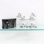 Conjunto para café em porcelana. Composto por seis(06) xícaras com seus respectivos pires. Xícaras de formato cilíndrico com alças curvas; pires quadrangulares de cantos arredondados e perfil levemente recurvado. Decoração floral estilizada em preto sobre fundo branco, invertida nos pires. Acompanha caixa original coordenada à decoração do conjunto. Sem uso. Medidas xícara: Alt.: 5,5 x Comp.: 7 x Larg.: 5cm.Medidas pires: Comp.: 9,5 x Larg.: 9,5cm.