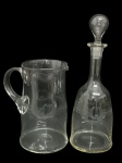 Conjunto com Jarra e garrafa de antigo cristal, com detalhe no bojo gravado, ao estilo Saint Louis (11 cm d x 20,5 cm alt.  e garrafa 31,5 cm alt. )