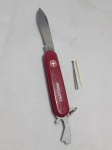 WENGER - Canivete Picnic equivalente direto ao modelo Victorinox Bantam. Possui apenas uma única camada de ferramentas, o que o torna extremamente fino, leve e ideal para carregar no bolso diariamente.  Conta com uma lâmina principal de corte e a icônica ferramenta combo na extremidade oposta. Essa peça multifuncional serve como abridor de garrafas, abridor de latas, chave de fenda e desencapador de fios. Acompanha palito de dente e pinça embutidos nas talas plásticas. Detalhes conforme fotos, _(ºLº)_ Caso necessite, tire todas suas dúvidas via atendimento personalizado por WhatsApp: (11) 98681-9377. Não deixe para última hora! Antecipadamente agradecemos pelo seu lance. Sem testes ou garantias futuras de originalidade, funcionalidade, material ou procedência.