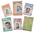 Lote composto por 6 revistas e cancioneiros musicais antigos, incluindo exemplares de Jornal de Modinhas Illustrado, Eirete Ñü, Ritmos e Melodias Inesquecíveis, com capas ilustradas por artistas e intérpretes da época. Apresentam sinais naturais de uso e envelhecimento. Maior exemplar: 27,5 cm.