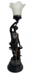 ART NOUVEAU - Escultura / luminária de mesa francesa, em petit bronze patinado, representando figura masculina em pose clássica junto a bigorna e elementos vegetais, sustentando tulipa em pasta de vidro fosco frisado. Base circular em madeira de dois níveis e selo de fundição francesa, ao lado assinatura ilegível. Peça de elegante inspiração Art Nouveau, rica em detalhes escultóricos. Medida: 68 cm de altura (considerando a manga/tulipa).