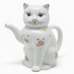 PORCELANA - Lindo bule em formato de gato, delicadamente decorado com flores, detalhes prateados. Med. 14x13x8 cm. Marcas do tempo e de uso.