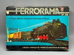 BRINQUEDO - Clássico Ferrorama XP 200 da marca Estrela (Ref. 22.41.21), conhecido como o primeiro trem elétrico automático fabricado no Brasil, completo em sua caixa original com berço de isopor, incluindo a locomotiva a vapor preta com detalhes vermelhos, vagão tender, vagão de carga fechado, vagão-tanque da Shell, trilhos curvos e retos, desvios com sistema de comando, cancela, postes de sinalização e acessórios originais em excelente estado de preservação.