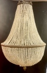 Belíssimo lustre francês no estilo império,                                                                                       no formato de pera, apresentando estrutura em  bronze e cordões em cristais.                                                                                                                                 Alt. 100 cm  x  Diâm. 65 cm.