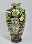 OFICINA DE TIAN DE XIANG - CHINA, PERÍODO GUANG XU (1875-1908) - Antigo vaso em elaborado cloisonné chinês, decoração "Cem Antiguidades" sobre fundo negro. Base assinada em chines tradicional, localizando Pequim e o nome do estudio e a transliteração em inglês para exportação: TIEN TEH HSIANG. Séc.XIX/XX. Mede: 32 cm. Acompanha base em madeira. Altura total com base: 36 cm. Item recentemente limpo e conservado conforme foto extra. SOBRE A OFICINA --- A oficina Tian De Xiang de Pequim pertence ao seleto grupo de ateliês privados de esmalte cloisonné da virada do século XIX para o XX (como a famosa Lao Tian Li , De Xing Cheng  e Jing Yuan Cheng ), que produziam tanto peças de alto padrão para as elites locais quanto itens de luxo para embaixadas, diplomatas e exportação ocidental.