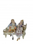 Meissen, séc. XVIII - Magnífico conjunto escultórico em porcelana policromada, representando casal de nobres `em conversa sobre um recamier, finamente detalhado`. -dim- 15x9x11 cm.