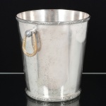 METAL PRATEADO, uma (1) champanheira obcônica, borda e base reforçada e relevada em frisos intercalados por tracejados e flores no padrão Império Napoleônico, alças idem, marca WOLFF (tradição desde 1894), medindo 22 cm altura e 20 cm diâmetro, vide foto.