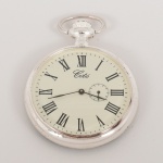 RELÓGIO, um (1) de algibeira (bolso), CÓPIA de relógio antigo, mostrador com algarismos romanos, caixa em metal prateado, tampa traseira relevada com elementos vegetalistas esmaltados em negro, medindo 46 mm diâmetro, mecanismos a corda, funcionando e sem garantia, vide foto.