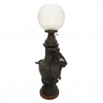 Luminária em petit bronze (liga de zinco antimônio) patinado. de formato balaústre, ornamentado por escultura representando jovem mulher. Bojo abaulado, encimado por queimador e regulador de chama. Globo liso, realçado por frisos em treliça. Base circular em mármore avermelhado. Assinada provavelmente Auguste ou François Moreau.