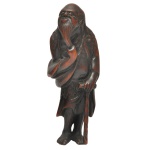 SÉC. XVIII - Grande e excepcional netsuke esculpido em boxwood, representando um Tekkai Sennin, figura de Imortal do repertório taoísta, alisando sua barba e segurando um cajado. 8,8 cm.