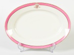 CH. PILLIVUYT - Travessa em porcelana francesa esmaltada e vitrificada na cor branca, bordas decoradas com faixa rosa, fio dourado e monograma. Medidas: 5 x 49,5 x 27,5cm.