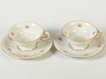 KPM - Par de xícaras para café e pires, em porcelana polonesa esmaltada e vitrificada na cor branca, decorada com motivos florais e fio dourado nas bordas. Altura da xícaras: 4,5cm.