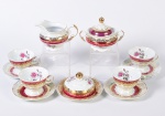 SCHMIDT- Parte de serviço para chá em porcelana esmaltada decoração floral constando 01 açucareiro, 01 manteigueira (apresenta fio de cabelo na tampa),01 leiteira e 04 xicaras c/ pires.