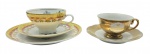 SZAKMARY ARS BOHEMIA / REAL - 01 xícara com seu respectivo pires adornados em dourado, da manufatura Szakmary Ars Bohemia; e 01 conjunto com xícara e seus respectivos pires e prato de sobremesa, ornamentados com motivos florais e vegetalistas em dourado, e coloridos buquês florais, da manufatura Real. Em porcelana; fabricação brasileira. Medidas: 15 x 7 cm; 19 x 8 cm. Xícara com ínfimo bicado e douração desvanecida em alguns pontos (Szakmary Ars Bohemia).