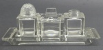 Conjunto de condimentos composto por 01 saleiro, 01 pimenteiro, 01 açucareiro e 01 bandeja retangular; em cristal translúcido. Medidas: 18 x 8 cm. Tampa de um dos frascos ausente; açucareiro sem colher.