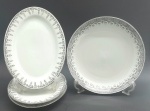 JINGDEZHEN, MADE IN CHINA - Parte de serviço de jantar em porcelana com 01 travessa circular e 03 travessas ovais de mesmo tamanho, decoradas na borda com arabescos e motivos florais na cor preta e filetes prateados. Fabricação chinesa, na cidade de Jingdezhen, mundialmente famosa por sua produção de porcelana. Medidas: 29,5 x 5 cm; 31 x 22 cm.