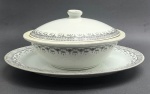 JINGDEZHEN, MADE IN CHINA - Parte de serviço de jantar em porcelana com 01 terrina e 01 travessa oval, decoradas na borda com arabescos e motivos florais na cor preta e filetes prateados. Fabricação chinesa, na cidade de Jingdezhen, mundialmente famosa por sua produção de porcelana. Medidas: 27 x 15 cm; 36 x 26 cm. Filetes prateados ligeiramente desvanecidos em alguns pontos.