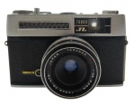 TARON JL - Antiga máquina fotográfica fabricada no Japão, tipo analógica, com lente Taromar F.C. 1:2.8 40mm. Acompanha capa em couro. Peça de colecionador. Não testada.