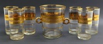 Conjunto composto por 01 balde para gelo e 06 copos no formato cilíndrico, em cristal translúcido decorado com faixas e filetes dourados, e elementos ovais lapidados; alças laterais do balde para gelo com douração total. Medidas: 17 x 15 cm; 14 x 7,5 cm.