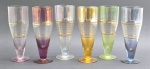 06 taças tipo tulipa adornadas com faixas de diferentes cores e filetes e faixas em dourado; em cristal translúcido. Medidas: 18 x 7 cm. Faixas coloridas esmaecidas; filetes e faixas em dourado esmaecidos em algumas taças.