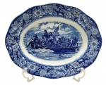 LIBERTY BLUE, HISTORIC COLONIAL SCENES, MADE IN ENGLAND - Parte de serviço de jantar com 01 travessa oval em porcelana inglesa, adornada em azul cobalto com motivos florais e vegetalistas na borda, e cenário com "Washington Crossing The Delaware", nos EUA. Medidas: 35 x 28 cm.