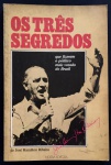 livro - Os Três Segredos: que Fizeram o Político Mais Votado do Brasil - José Hamilton Ribeiro - Nossa Editora - 1987 - 144 p. - dedicatória com autógrafo do autor na primeira folha - brochura com marcas do tempo na capa e miolo amarelado - (21X14) cm.