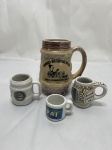 Lote de 4 canecas em porcelana. Medindo o maior 11cm de altura.