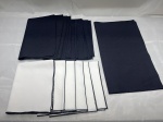 Jogo de caminho de mesa e 6 guardanapos em tecido branco e 6 guaradanapos em tecido preto. Medindo 50cm x 42cm. Com marcas de guardado.
