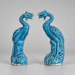 Par de esculturas decorativas chinesas em cerâmica esmaltada em tom azul-turquesa, representando fênix (fenghuang). Medindo: 10 x 4 cm. cada. Aves mitológicas de longa tradição na iconografia chinesa. Cada peça apresenta corpo alongado, pescoço sinuoso, cabeça com crista e bico recurvado, asas e plumagem trabalhadas em relevo, apoiadas sobre bases moldadas com elementos vegetais.
